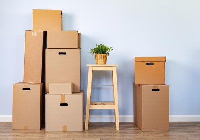 moving-boxes-with-packed-stuff-and-chair-for-movin-6PYMJC8